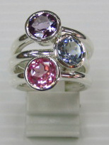 sterling silver Amethyst , blue topaz and pink topaz rings worn together.